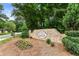 Stone entrance to Madison Woods, featuring manicured landscaping and mature trees at 4401 Madison Woods Nw Dr, Marietta, GA 30064