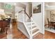Welcoming entryway with hardwood floors, staircase, and views into the living room and dining room at 4401 Madison Woods Nw Dr, Marietta, GA 30064