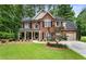 Charming two-story brick home with well-manicured lawn and inviting front porch at 4401 Madison Woods Nw Dr, Marietta, GA 30064