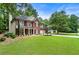 Beautifully landscaped lawn and two-story brick home, perfect for a Gathering at 4401 Madison Woods Nw Dr, Marietta, GA 30064