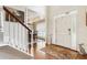 Elegant foyer features hardwood floors, white staircase, and a decorative rug at 4401 Madison Woods Nw Dr, Marietta, GA 30064