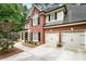 Exterior view of the brick home, featuring a two-car garage and inviting porch at 4401 Madison Woods Nw Dr, Marietta, GA 30064