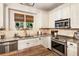 Stylish kitchen with white cabinets, granite countertops, and stainless steel appliances at 4401 Madison Woods Nw Dr, Marietta, GA 30064