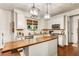 Modern kitchen featuring white cabinets, granite countertops, and a wood-top island at 4401 Madison Woods Nw Dr, Marietta, GA 30064