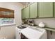 Well-lit laundry room featuring modern appliances and ample cabinet space at 4401 Madison Woods Nw Dr, Marietta, GA 30064