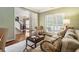 Inviting living room with a neutral color palette, plantation shutters, and lots of natural light at 4401 Madison Woods Nw Dr, Marietta, GA 30064