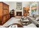 Cozy living room with a fireplace, stylish furniture, and beautiful hardwood floors at 4401 Madison Woods Nw Dr, Marietta, GA 30064