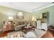 Comfortable living room with plush sofa, custom cabinetry, and hardwood floors at 4401 Madison Woods Nw Dr, Marietta, GA 30064