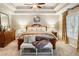 This main bedroom features a bench, lots of natural light, and a beautiful dresser at 4401 Madison Woods Nw Dr, Marietta, GA 30064