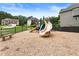 Playground area featuring multiple slides, play structures, and a wood chip ground cover at 4401 Madison Woods Nw Dr, Marietta, GA 30064