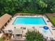Aerial view of large community swimming pool surrounded by lounge chairs and cabanas at 4401 Madison Woods Nw Dr, Marietta, GA 30064