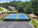 Community tennis courts featuring well-maintained blue courts, green fencing, and a covered picnic area at 4401 Madison Woods Nw Dr, Marietta, GA 30064