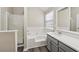 Modern bathroom featuring a shower, soaking tub, and updated vanity with quartz countertop at 4464 Idlewood Park, Lithonia, GA 30038