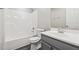 Bathroom with a combined shower and tub, modern vanity and white tiling at 4464 Idlewood Park, Lithonia, GA 30038
