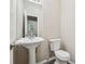 Powder room features modern pedestal sink, brushed nickel faucet, and standard toilet at 4464 Idlewood Park, Lithonia, GA 30038