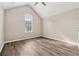 Bedroom featuring a vaulted ceiling, neutral colors, and hardwood flooring at 4464 Idlewood Park, Lithonia, GA 30038