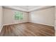 Large bedroom with tray ceiling, hardwood floors and a window with green view at 4464 Idlewood Park, Lithonia, GA 30038