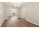 Dining room featuring hardwood floors, a modern chandelier and a view to the living room at 4464 Idlewood Park, Lithonia, GA 30038