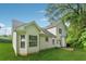 Rear exterior view of this two-story home featuring white vinyl siding and well-manicured lawn at 4464 Idlewood Park, Lithonia, GA 30038