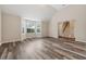 Bright living room boasts luxury vinyl plank flooring and vaulted ceilings near an entry stairway at 4464 Idlewood Park, Lithonia, GA 30038