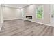Open-concept living room with stylish flooring, modern fireplace, and bright windows at 4464 Idlewood Park, Lithonia, GA 30038
