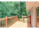 Wooden back deck offers a secluded outdoor space surrounded by lush greenery and trees at 1863 Rockford Ct, Riverdale, GA 30296