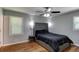Comfortable bedroom with wood floors, ceiling fan, and a large window for natural light at 1863 Rockford Ct, Riverdale, GA 30296
