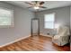 Bright bedroom featuring wood-look flooring, a large window, and ample natural light at 1863 Rockford Ct, Riverdale, GA 30296