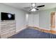 Well-lit bedroom featuring hardwood floors, and a view into an attached bathroom and walk-in closet at 1863 Rockford Ct, Riverdale, GA 30296