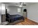 Comfortable bedroom with a ceiling fan, wood flooring, and dresser with TV on top at 1863 Rockford Ct, Riverdale, GA 30296