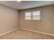 Neutral bedroom with carpet, featuring a window with blinds, providing natural light and privacy at 1863 Rockford Ct, Riverdale, GA 30296