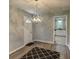 Charming dining room featuring a modern chandelier and an open layout leading to the kitchen at 1863 Rockford Ct, Riverdale, GA 30296