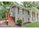 Side view of a charming gray painted brick home with a wooden porch and shutters at 1863 Rockford Ct, Riverdale, GA 30296