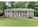 Charming home with a well-manicured lawn and beautiful, gray painted brick exterior at 1863 Rockford Ct, Riverdale, GA 30296