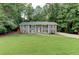 Charming home with a well-manicured lawn and beautiful, gray painted brick exterior at 1863 Rockford Ct, Riverdale, GA 30296