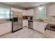 Well-lit kitchen featuring stainless steel appliances, granite countertops, and white cabinets at 1863 Rockford Ct, Riverdale, GA 30296