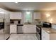 Bright kitchen features stainless steel appliances, granite countertops, and white cabinets at 1863 Rockford Ct, Riverdale, GA 30296