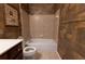 Cozy bathroom featuring a tub/shower combo, tiled walls, and dark wood cabinets at 2940 Bentbill Xing, Cumming, GA 30041