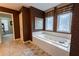 This bathroom features a large tiled tub and stylish tiling, leading to another room at 2940 Bentbill Xing, Cumming, GA 30041