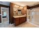 A bathroom featuring a vanity with a large mirror and a glass-doored shower stall is shown at 2940 Bentbill Xing, Cumming, GA 30041