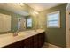 Bathroom with double sink vanity, large mirror, and neutral wallpaper at 2940 Bentbill Xing, Cumming, GA 30041