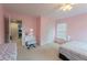 This bedroom is painted pink and features multiple beds, a vanity, and carpet flooring at 2940 Bentbill Xing, Cumming, GA 30041