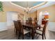 Elegant dining room with a large table, wood floors, decorative ceiling, and chandelier at 2940 Bentbill Xing, Cumming, GA 30041