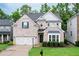 Charming two-story home with brick facade, manicured lawn, and attached two-car garage at 2940 Bentbill Xing, Cumming, GA 30041