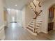A grand foyer with soaring ceilings, elegant wainscoting, and light wood-look floors at 2940 Bentbill Xing, Cumming, GA 30041