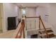 Hallway with wooden railings, staircase, and gray walls at 2940 Bentbill Xing, Cumming, GA 30041