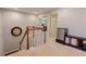 A cozy landing area with a clock, baby gate, and mini fridge at 2940 Bentbill Xing, Cumming, GA 30041