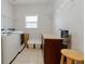 A bright laundry room featuring a modern washer and dryer, storage cabinets, and convenient overhead shelving at 2940 Bentbill Xing, Cumming, GA 30041