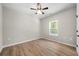 Bedroom with light wood laminate floors, ceiling fan, and a window at 389 Campground School Rd, Dallas, GA 30157