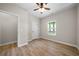 Bedroom with light-colored walls, wood flooring, a ceiling fan, and a window at 389 Campground School Rd, Dallas, GA 30157